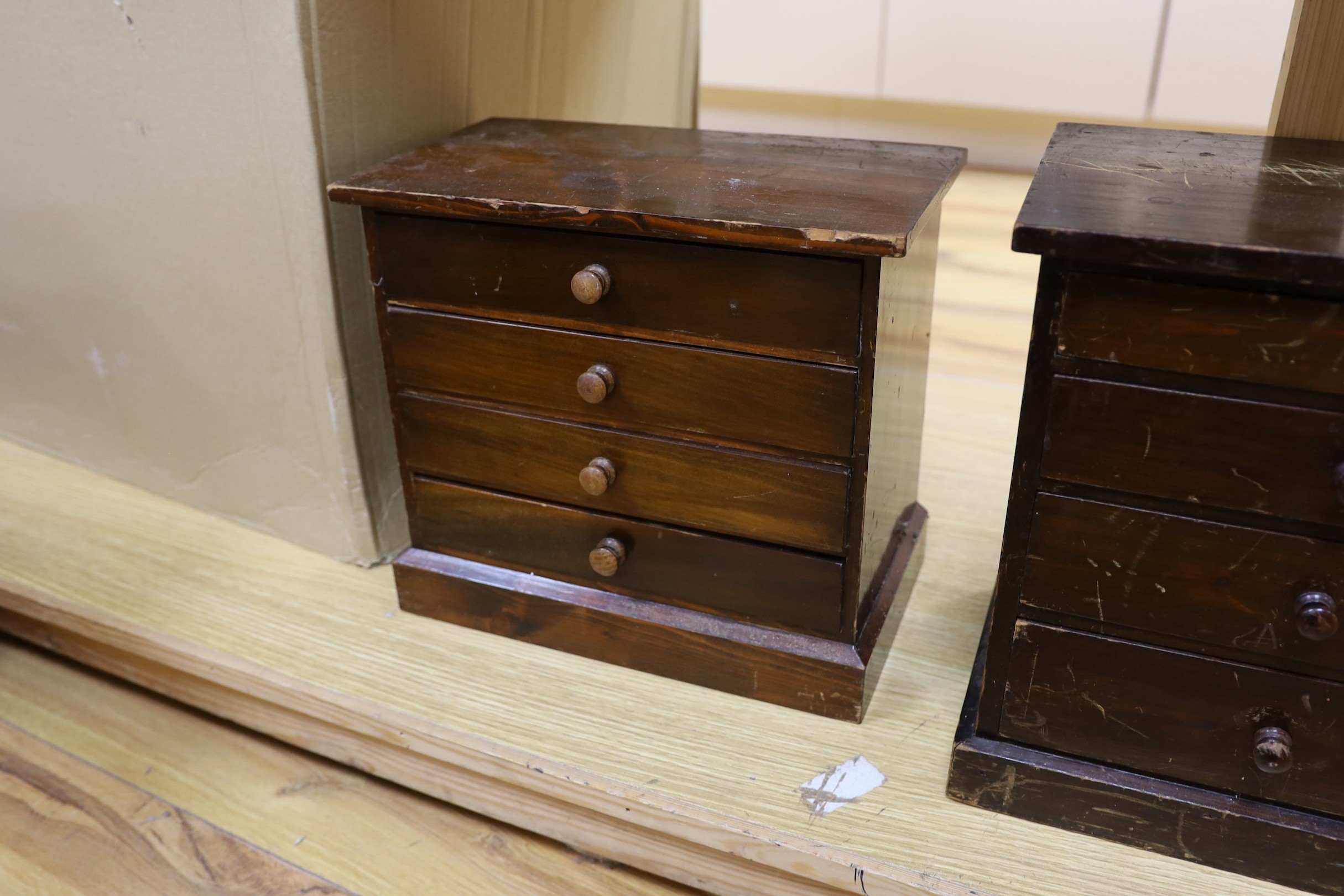Three miniature four drawer collector's chests, tallest 33cms high